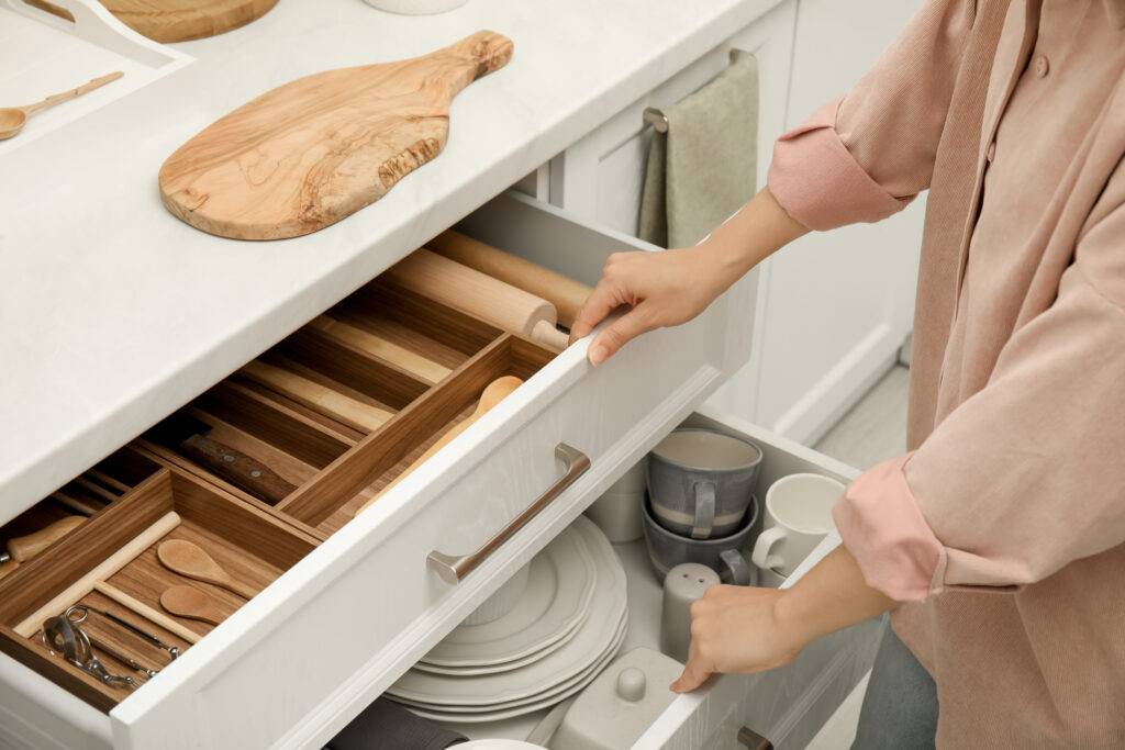 Private housekeeper supporting a busy family organizing draws