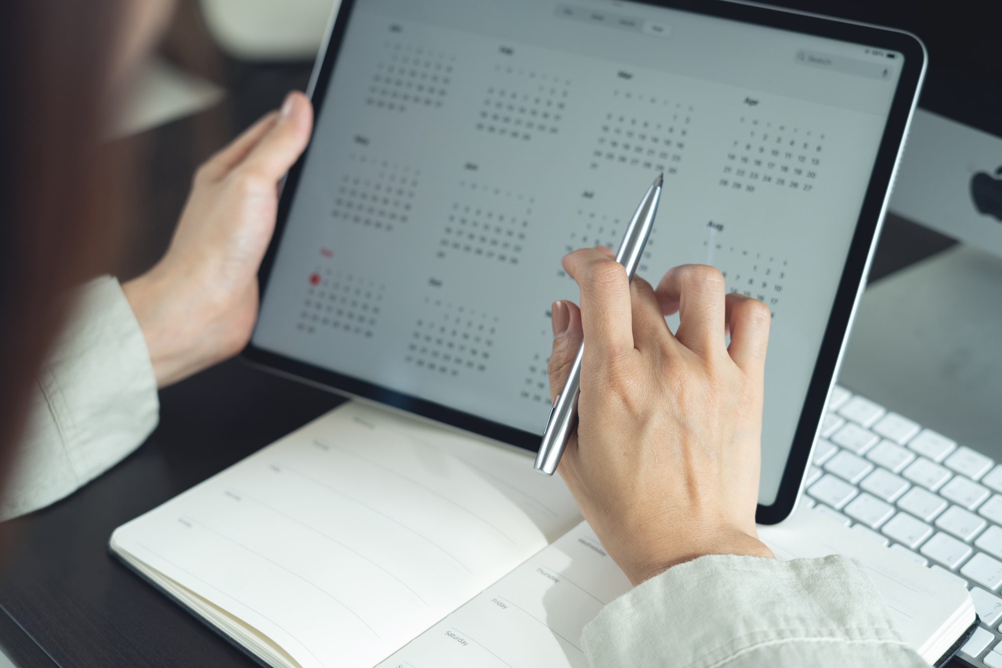 Estate manager coordinating household schedule and operations on tablet